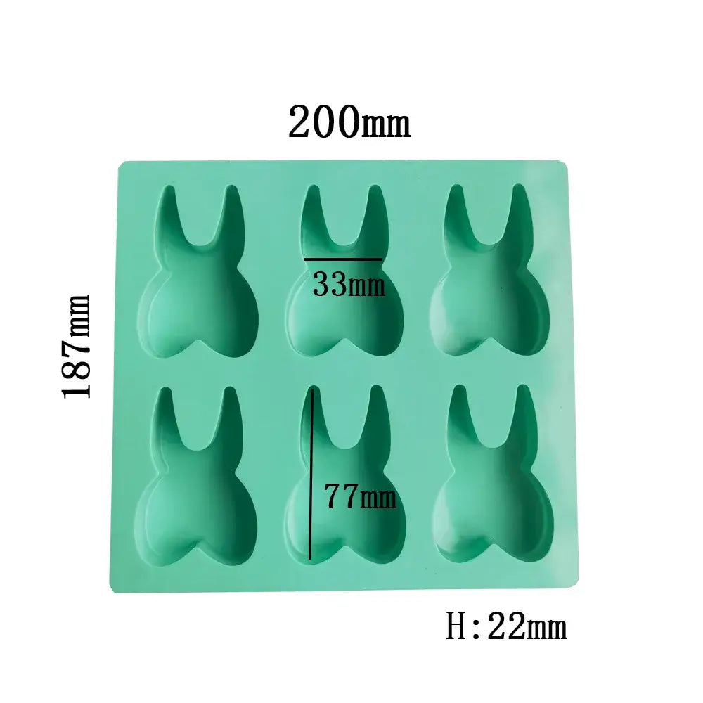 A mint green silicone mold with six bunny-shaped cavities from decorbites™ 6 hole tooth silicone mold collection