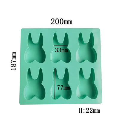 A mint green silicone mold with six bunny-shaped cavities from decorbites™ 6 hole tooth silicone mold collection