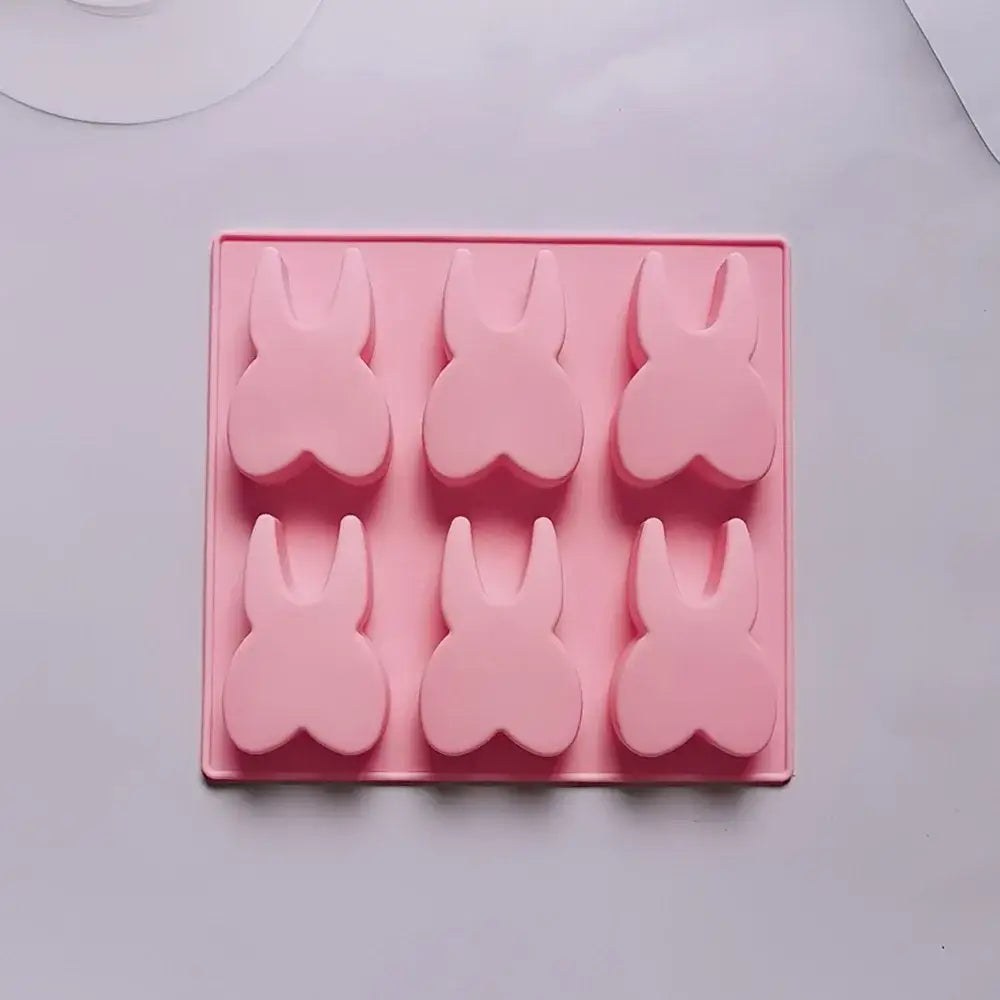 Pink silicone mold in bunny shape with six cavities for cake biscuit candy using hole tooth silicone design