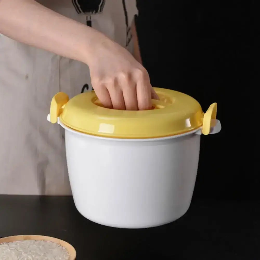 White plastic cooking pot with bright yellow lid and side handles for decorbites 6-in-1 meal preparation use