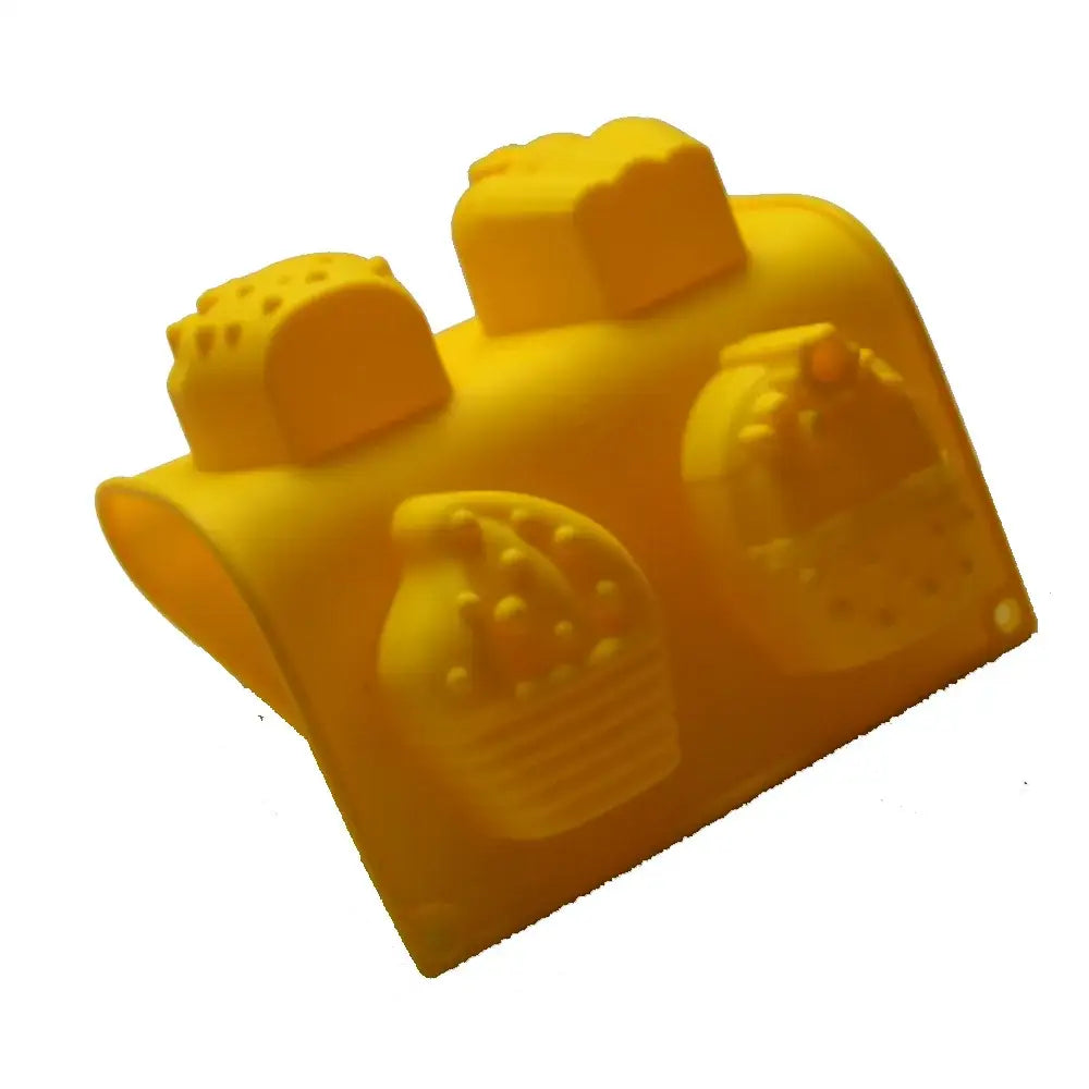 Bright yellow silicone ice cream cake mold shaped like a lego brick with embossed cookie and cake designs for kids party