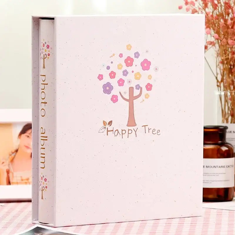A soft pink DecorBites™ 6-inch scrapbook album with happy tree design for family baby wedding memories