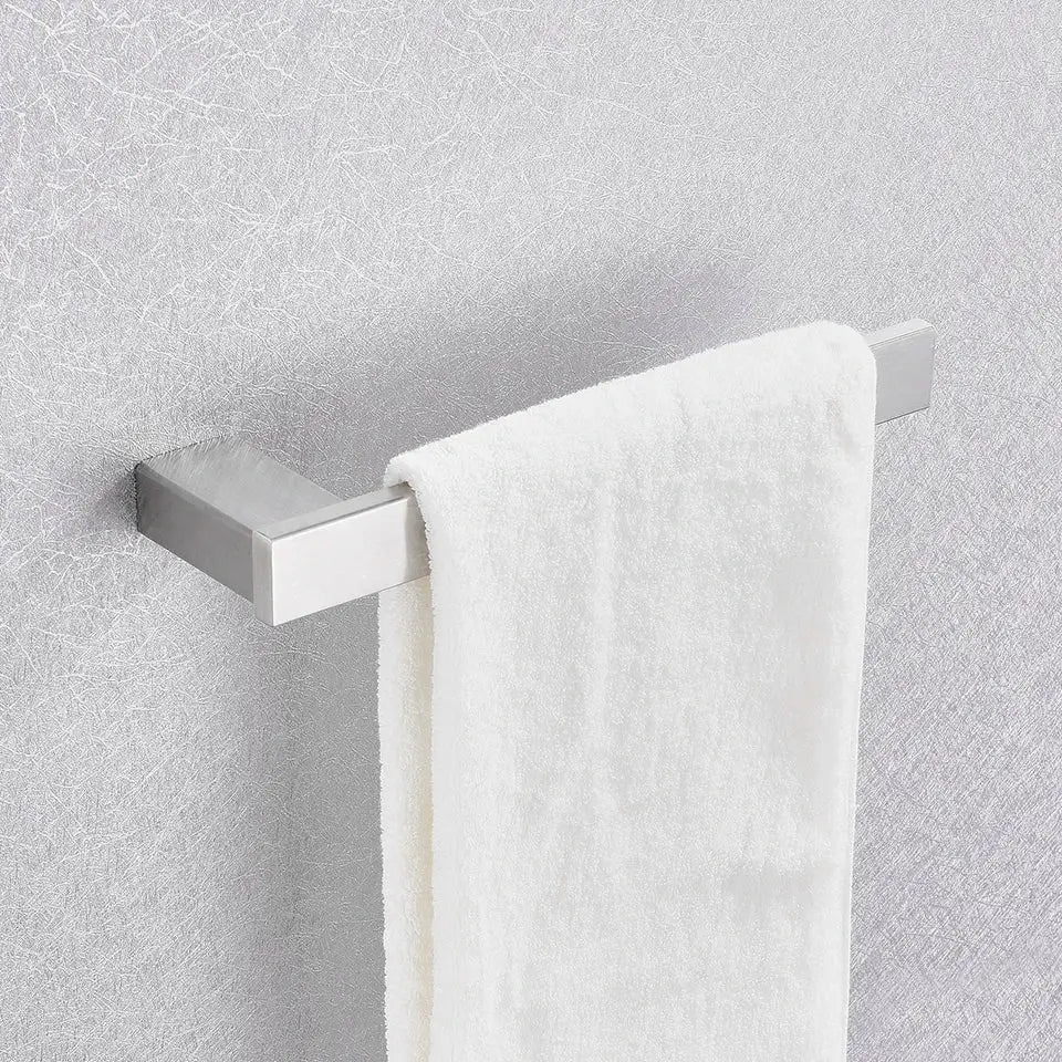 A sleek brushed nickel towel rack with a white terry cloth towel from the decorbites 6-piece bathroom accessories set