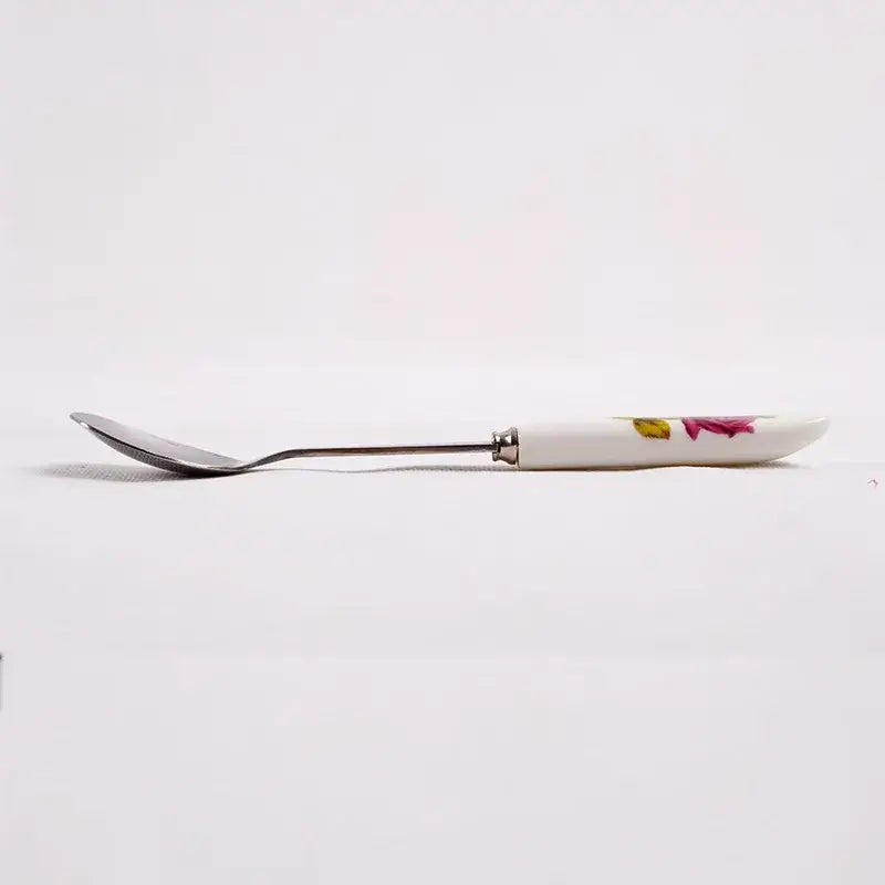 Decorbites™ coffee spoon set featuring a white ceramic spoon with floral design and polished stainless steel handle