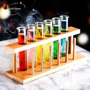 Wooden rack holding clear glass test tube cocktail glasses filled with colorful liquids from decorbites 6-piece set