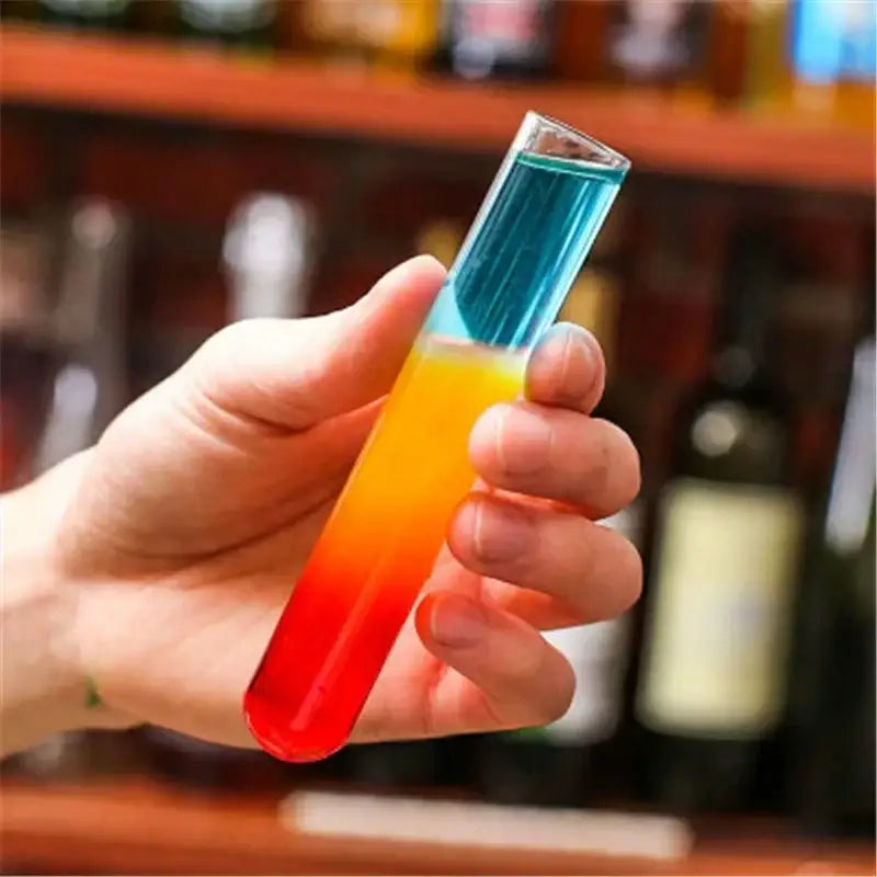 A clear glass test tube cocktail glass with a vibrant red orange and blue gradient from decorbites™ set