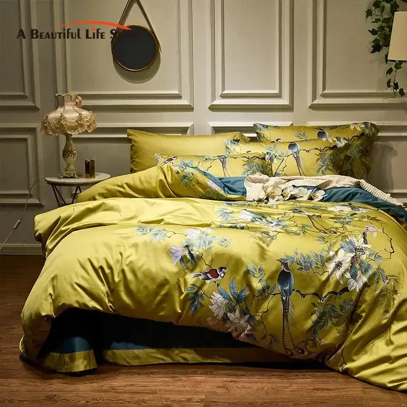 Vibrant yellow satin bedding set with intricate blue floral and bird embroidery made from 600tc Egyptian cotton
