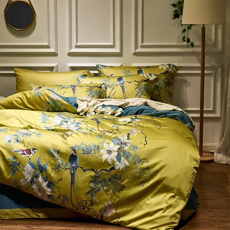 Yellow satin duvet cover with intricate blue and white floral and bird embroidery in 600tc egyptian cotton bedding set