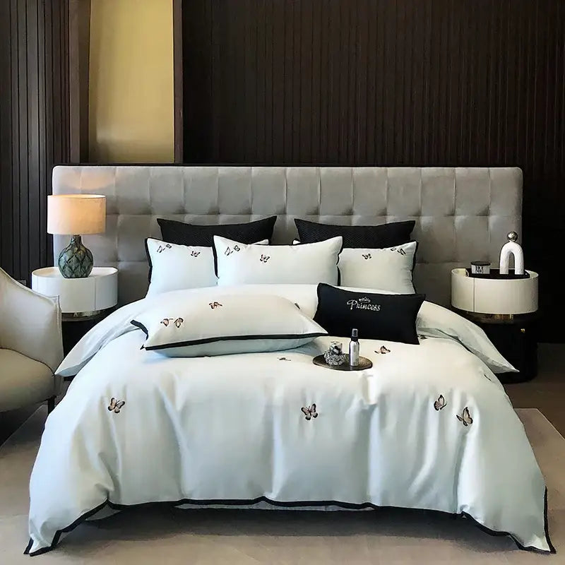 Elegant white satin bedding set with black butterfly embroidery and 600tc Egyptian cotton from DecorBites