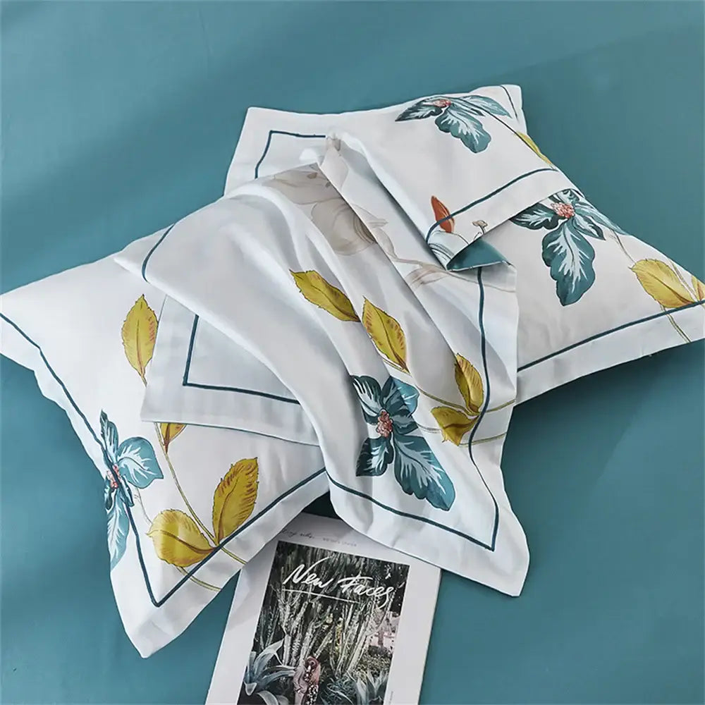 White pillowcases with teal and gold botanical print and navy piping from decorbites 600tc egyptian cotton bedding set