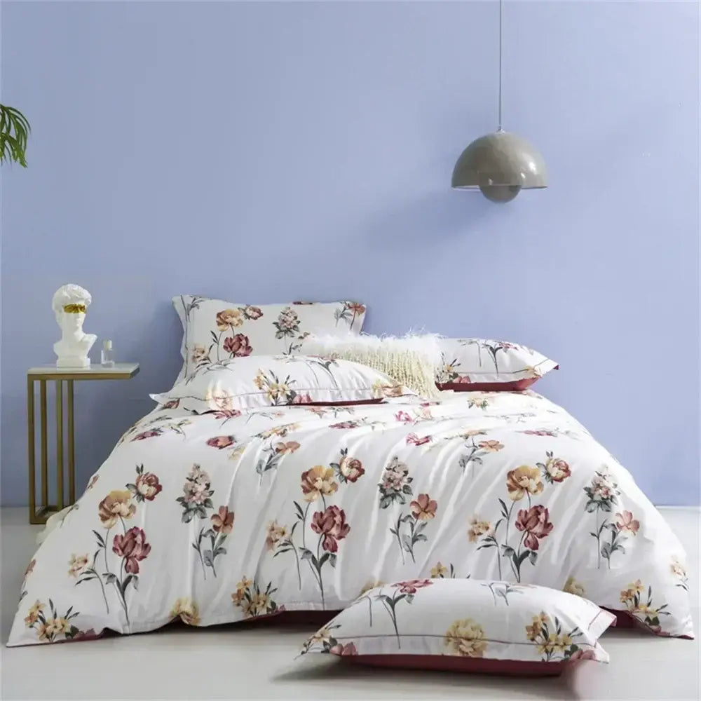 White duvet cover with delicate floral pattern in soft pink peach and green hues in decorbites 600tc egyptian cotton bedding set