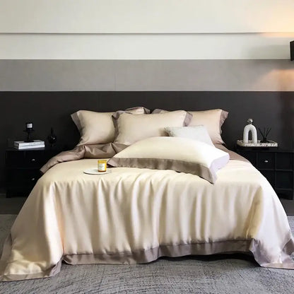 Cream-colored satin bedding set with subtle taupe border made from lyocell eucalyptus fiber for elegant comfort