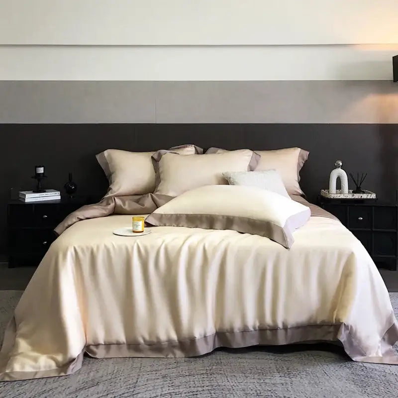 Cream-colored satin bedding set with subtle taupe border made from lyocell eucalyptus fiber for elegant comfort