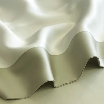 A soft cream-colored satin duvet cover from decorbites 600tc lyocell eucalyptus fiber bedding set with gentle folds