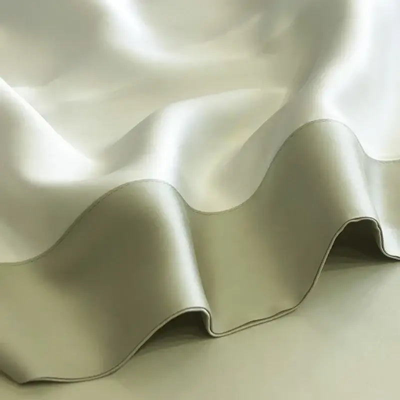 A soft cream-colored satin duvet cover from decorbites 600tc lyocell eucalyptus fiber bedding set with gentle folds