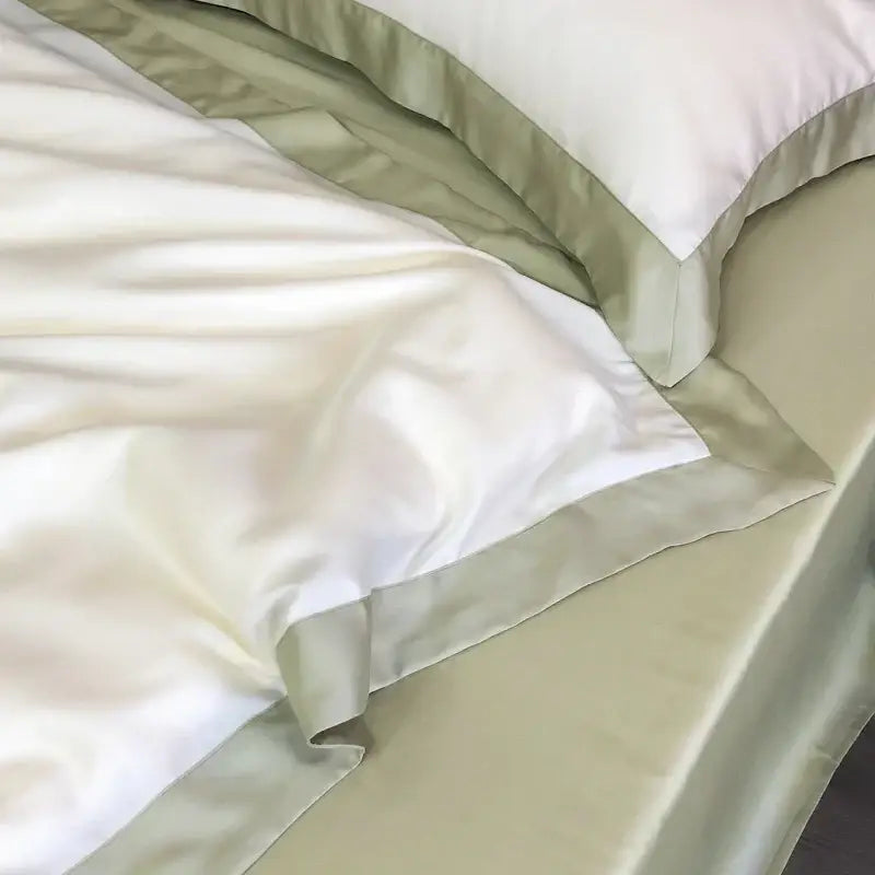 Cream-colored satin pillowcases with olive green ruffled trim from decorbites 600tc lyocell eucalyptus fiber bedding set