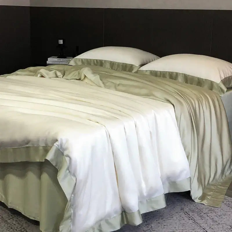 Cream-colored satin bedding set with sage green ruffled trim made from lyocell eucalyptus fiber by decorbites