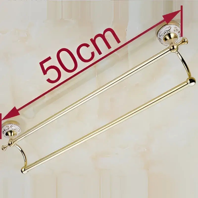 Gold-colored double towel bar with ceramic finish and ornate decorative end caps for bathroom accessories