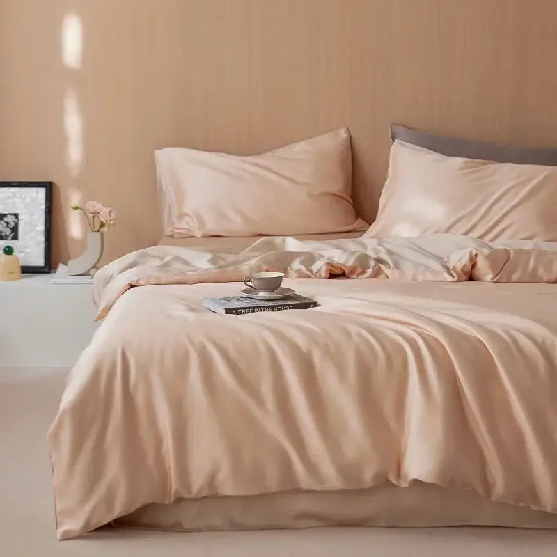 Soft peach satin duvet cover set with matching pillowcases featuring smooth 60s rayon silk bedding for summer cooling
