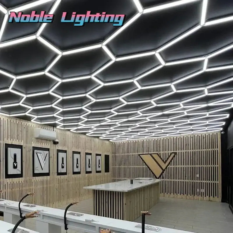 Black hexagonal ceiling panels with integrated white 6500k led hexagrid lighting strips for workshop and studio use
