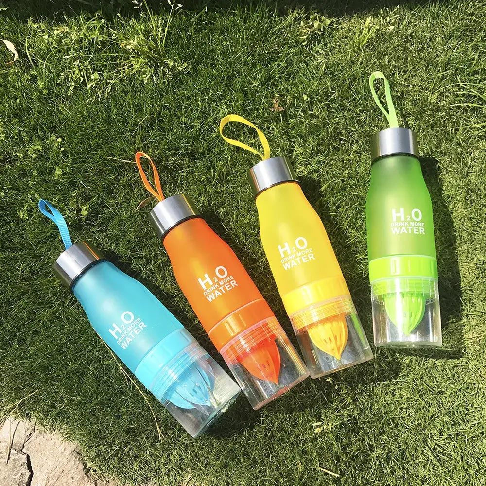 DecorBites 650ml infuser water bottle set in colorful translucent plastic with silver caps and matching handles on grass
