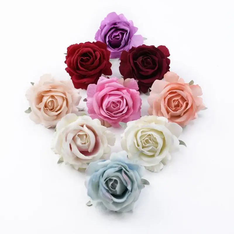 A collection of fabric artificial flowers featuring 6cm roses head in soft pastel and deep hues for wedding decor