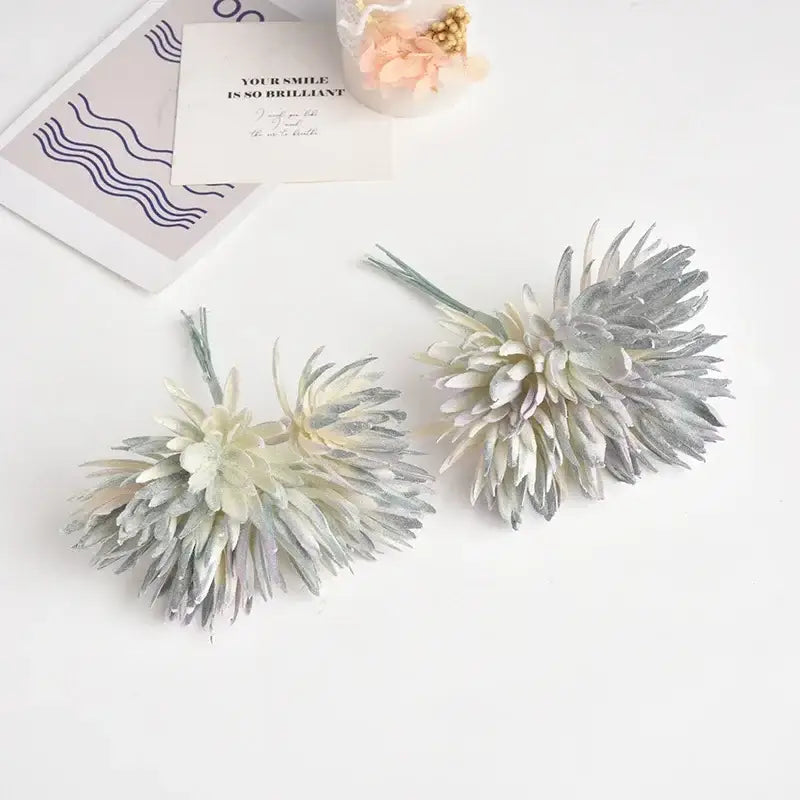 Two silk mini handmade artificial flowers with spiky layered petals in frosty silver and off-white for home decoration