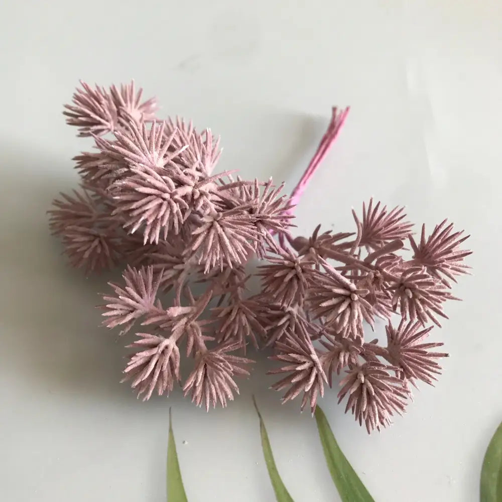 A cluster of dusty rose-colored artificial spruce branches from decorbites™ 6pcs dried flower mix for crafts
