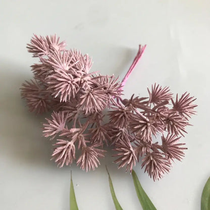 A cluster of dusty rose-colored artificial spruce branches from decorbites™ 6pcs dried flower mix for crafts