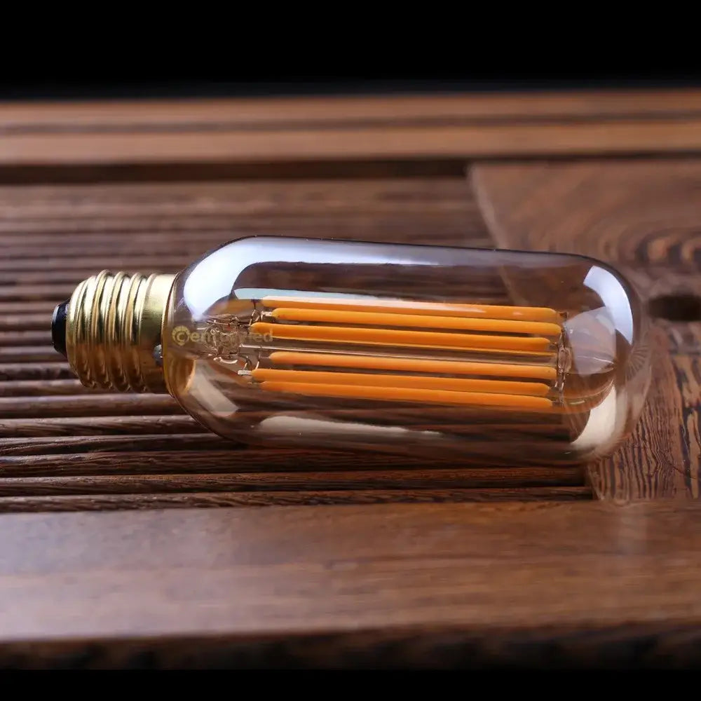 Clear glass DecorBites™ 220v led tubular filament bulb with brass base and warm orange led filaments 2200K dimmable