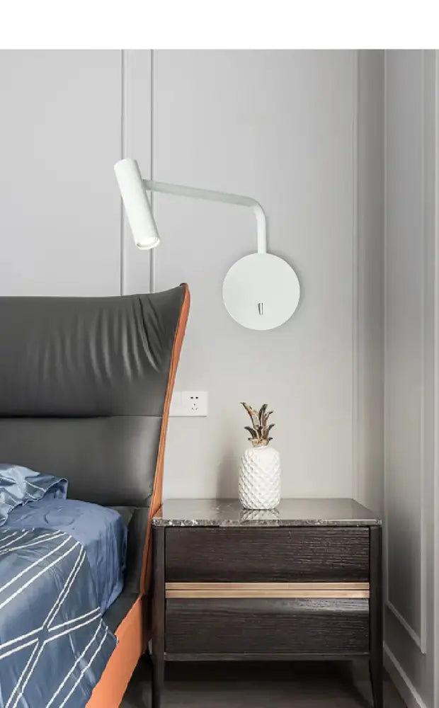 White textured pineapple-shaped vase with dried plants beside decorbites modern led wall lamp with reading light
