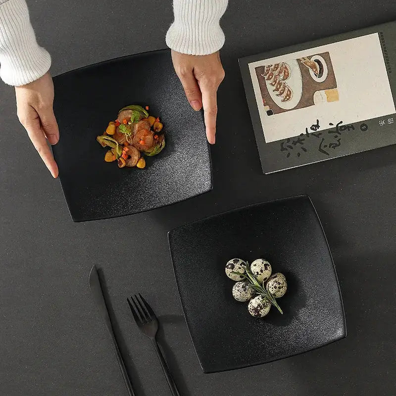Black matte 7.5 inch square ceramic dining plate with a speckled finish by decorbites