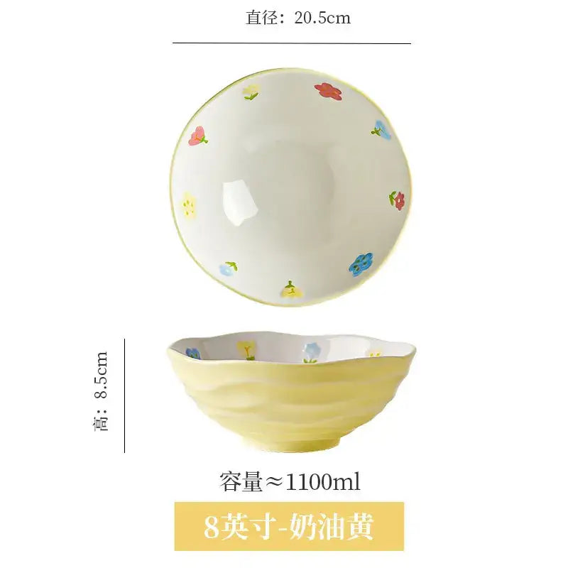 A creamy yellow ceramic ramen bowl with scalloped rim and hand-painted red blue and pink floral patterns by DecorBites
