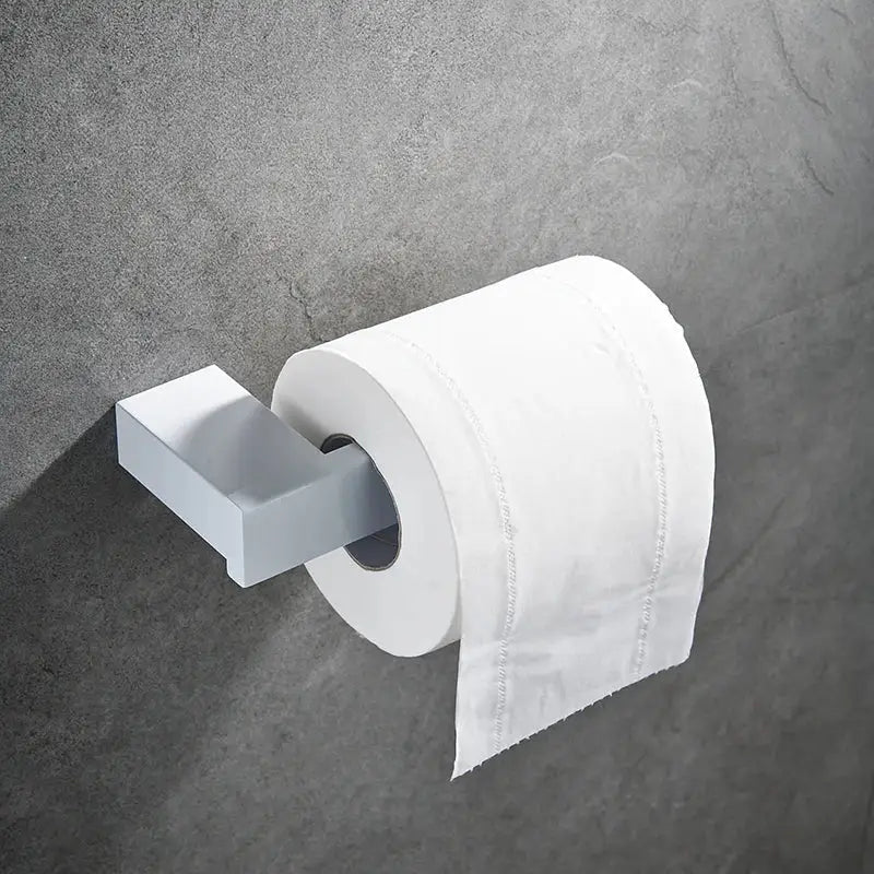 White toilet paper roll on a matte gray wall-mounted holder from the decorbites bathroom hardware set in white