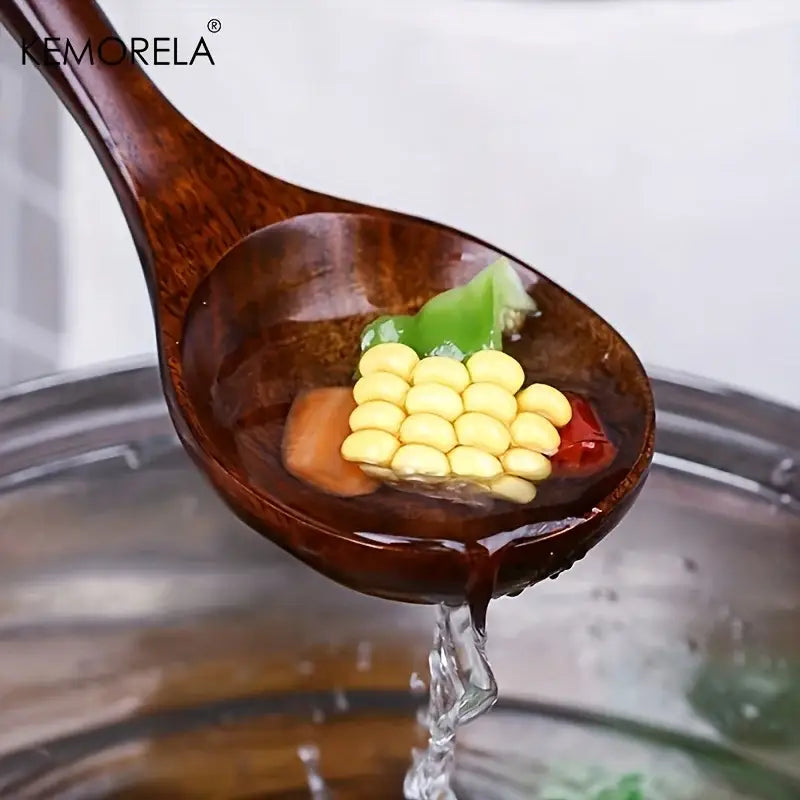 A rich dark brown eco-friendly thai wooden cooking spoon from decorbites 7-piece wooden cooking utensil set holding vegetables