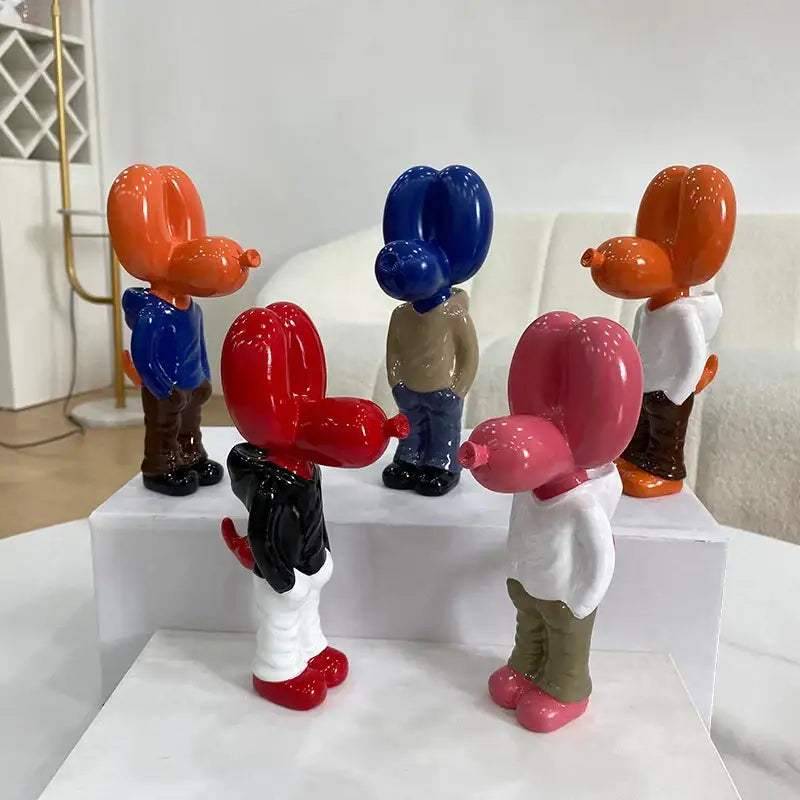 Vibrant glossy orange red blue and pink resin balloon dog statue figurines with detailed clothing and shoes by decorbites