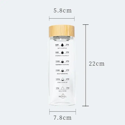 Decorbites 700ml glass water bottle with bamboo lid and measurement markings for hydration tracking and tea filtering
