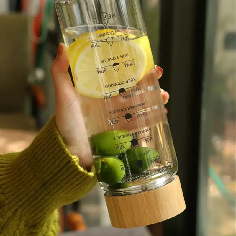 Decorbites™ 700ml clear glass water bottle with wooden base and hourly hydration time marker for daily use