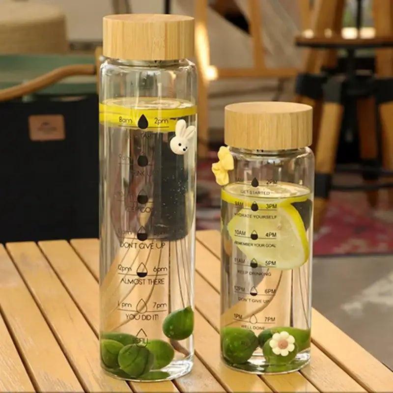 Decorbites™ 700ml glass water bottles with bamboo lids featuring white bunny and yellow flower charms for travel use