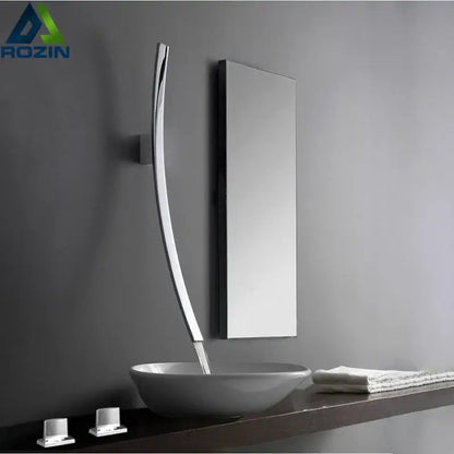 Modern chrome-finished basin mixer tap with sleek curved design wall mounted beside mirror above white vessel sink