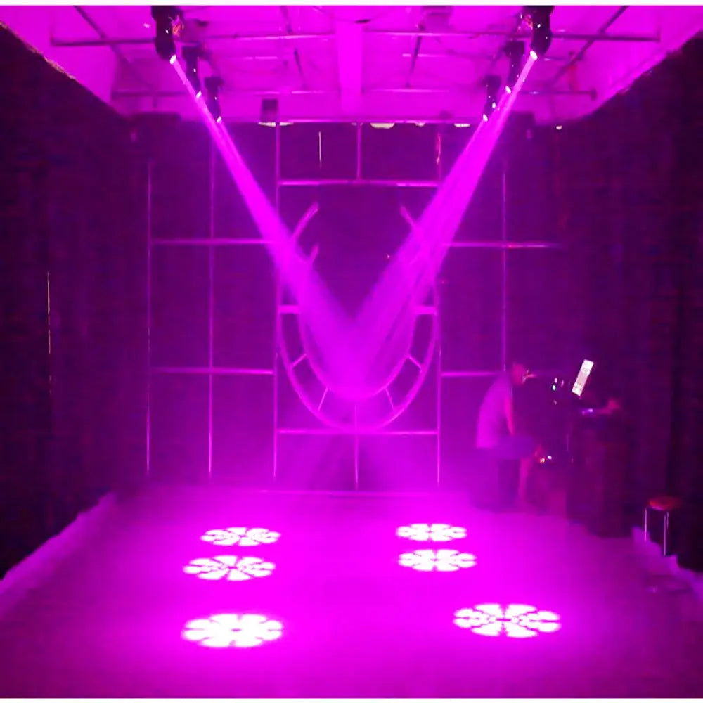 Purplish laser beams from the decorbites 75w led moving head illuminate floral gobos in a dark room setting
