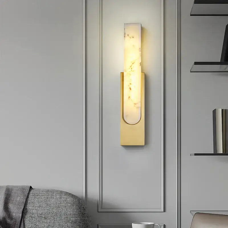 A sleek decorbites 7w led marble wall lamp with a warm glow and gold-toned frame for stylish indoor lighting