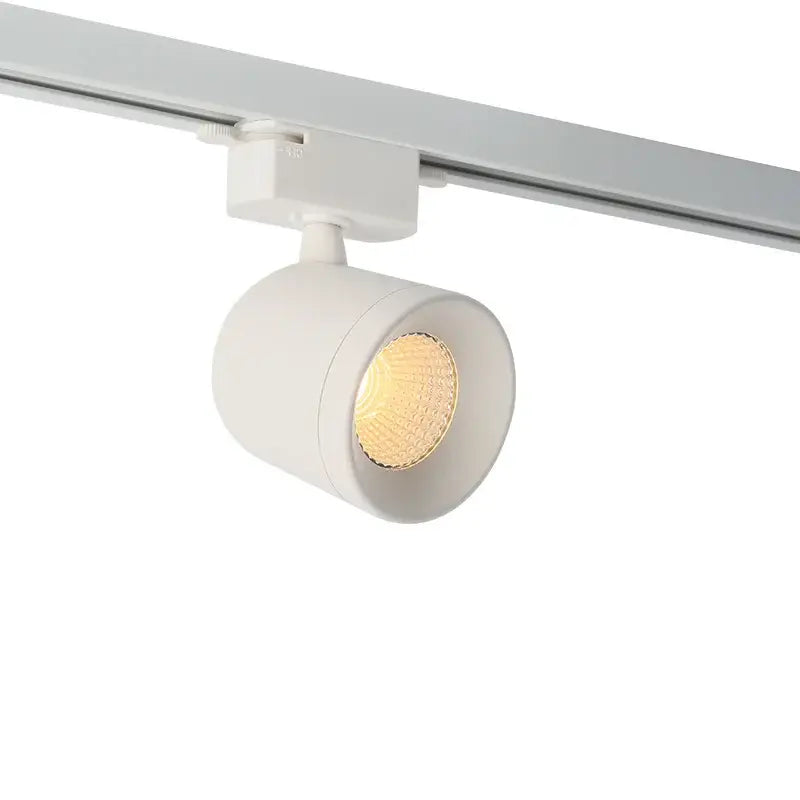 White cylindrical decorbites 7w led track light spotlight with warm glowing bulb in surface mounted aluminum fixture