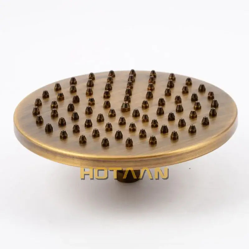Decorbites 8 inch copper round overhead rain shower head in antique brass finish with brass-colored circular nozzles