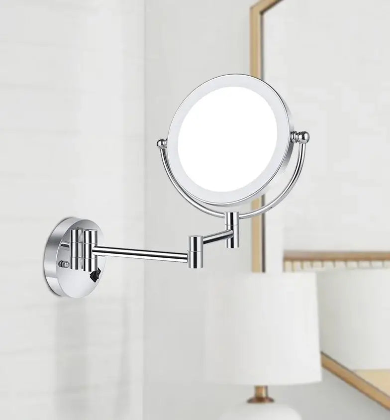 Chrome finished wall-mounted makeup mirror with circular illuminated face and adjustable articulated arm for precise use