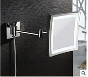 Silver-framed square brass magnifying wall mirror with LED lighting and 3X magnification for makeup and dressing