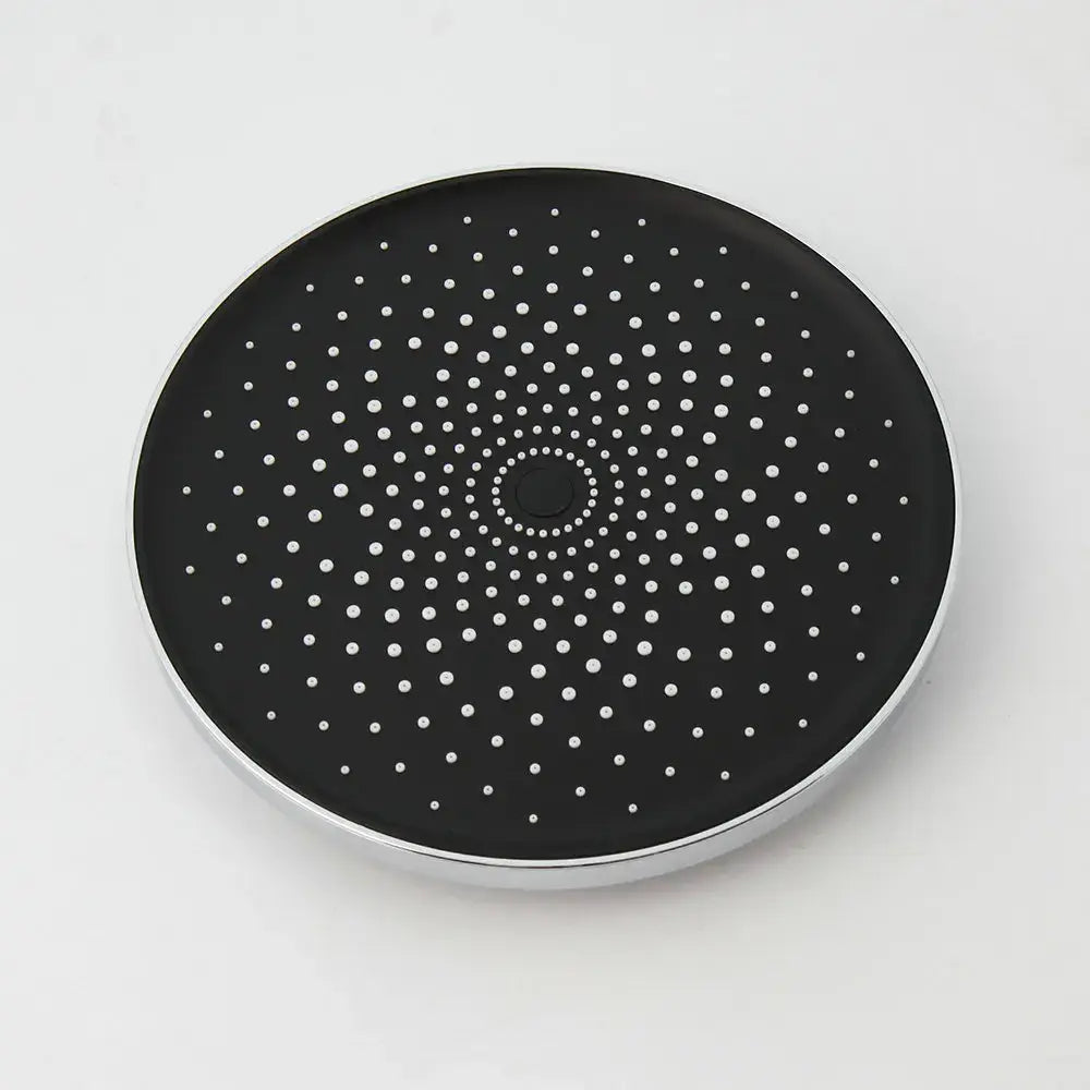 Black circular wireless charging pad with silver metallic rim and white perforated dots for stainless steel shower set