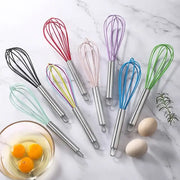 Set of colorful stainless steel silicone whisk mixers with 8-inch handles arranged on marble for baking and cooking