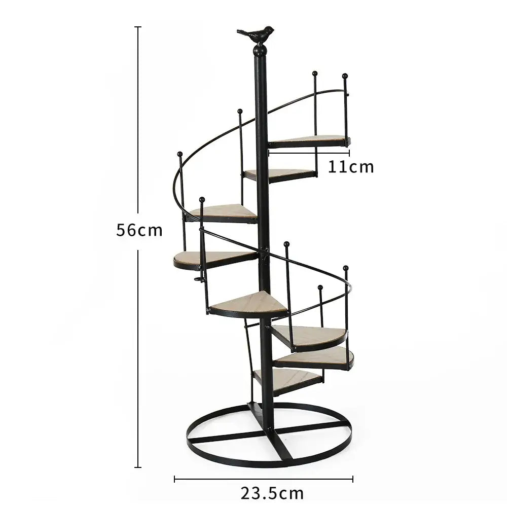 Black metal spiral staircase plant stand with wooden steps and bird finial featuring iron frame and wood plate design