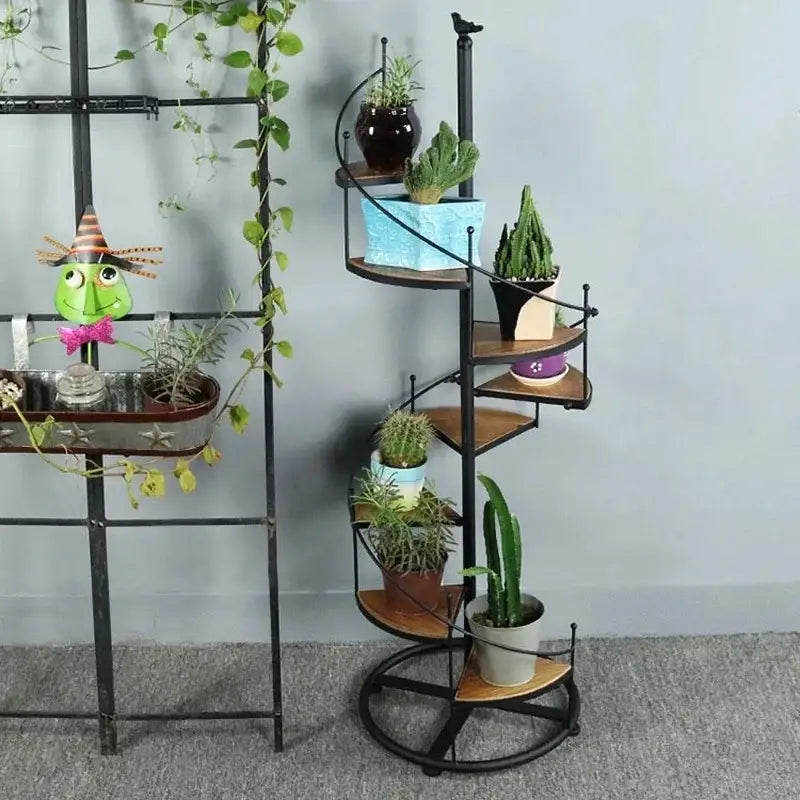 Black metal stair shape plant stand with wood plate holding potted cacti and succulents by decorbites